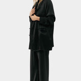 Silk Laundry black silk relaxed blazer worn open with matching trousers