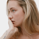 Bean Barrette Silver Wolf Circus worn in blonde hair sculptural silver hair clip close up