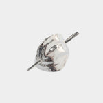 Close view sculptural silver hair pin high polish metal surface