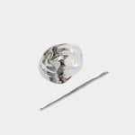 Silver bean shaped hair pin with stick detail flat lay