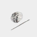 Silver bean shaped hair pin with stick detail flat lay