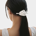 Back view silver French hair pin holding low ponytail smooth finish