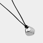 Wolf Circus Devon necklace silver organic pendant on black cord close up detail