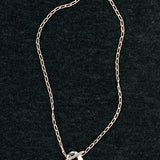 Wolf Circus Kaia necklace sterling silver curb chain on dark textured background