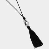 Miriam Necklace in silver Wolf Circus black cord tassel necklace flat lay sculptural pendant
