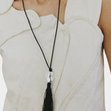 Miriam Necklace in silver Wolf Circus worn long necklace black tassel pendant on body