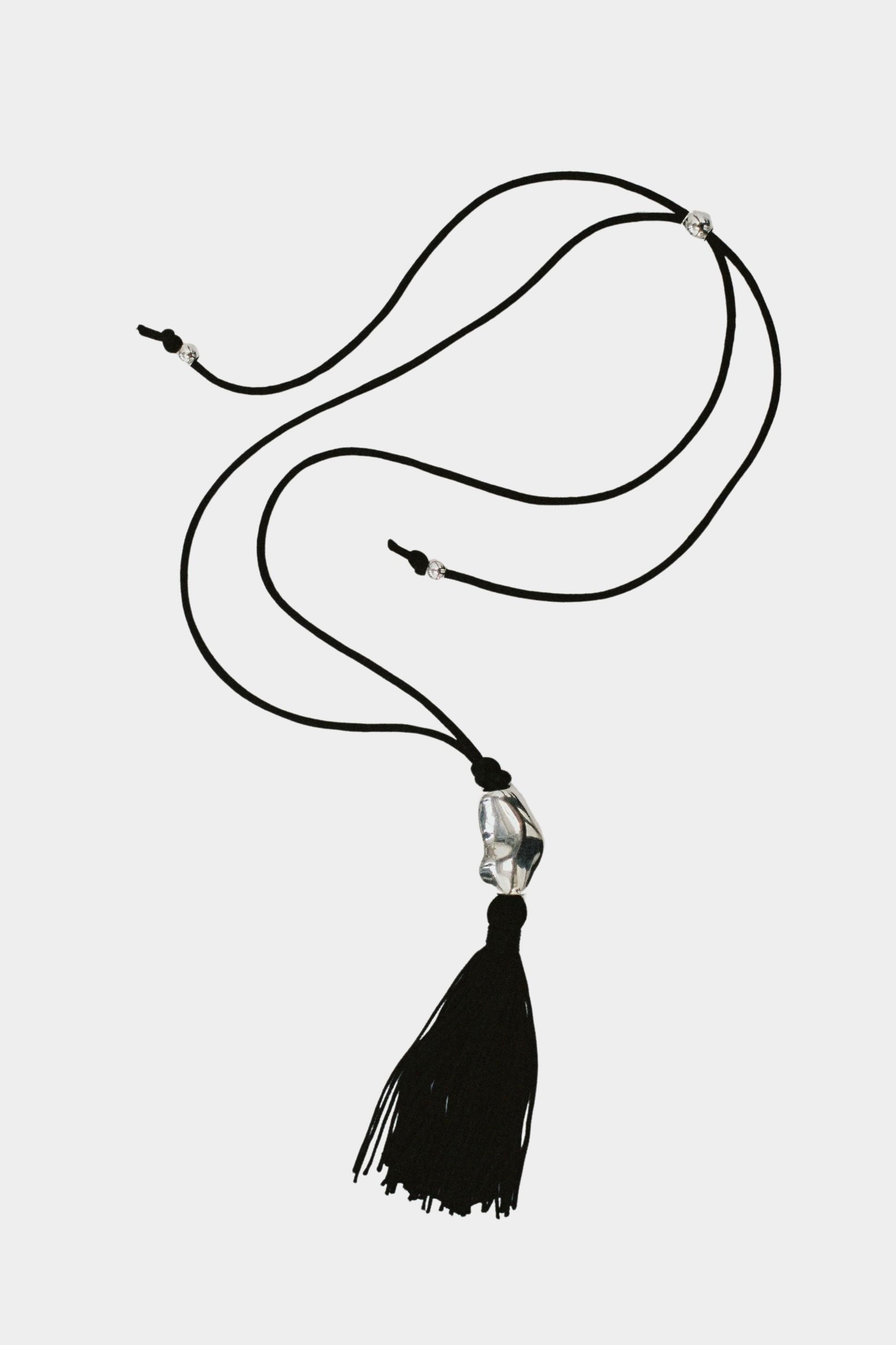 Miriam Necklace in silver Wolf Circus full necklace laid out adjustable black cord tassel pendant