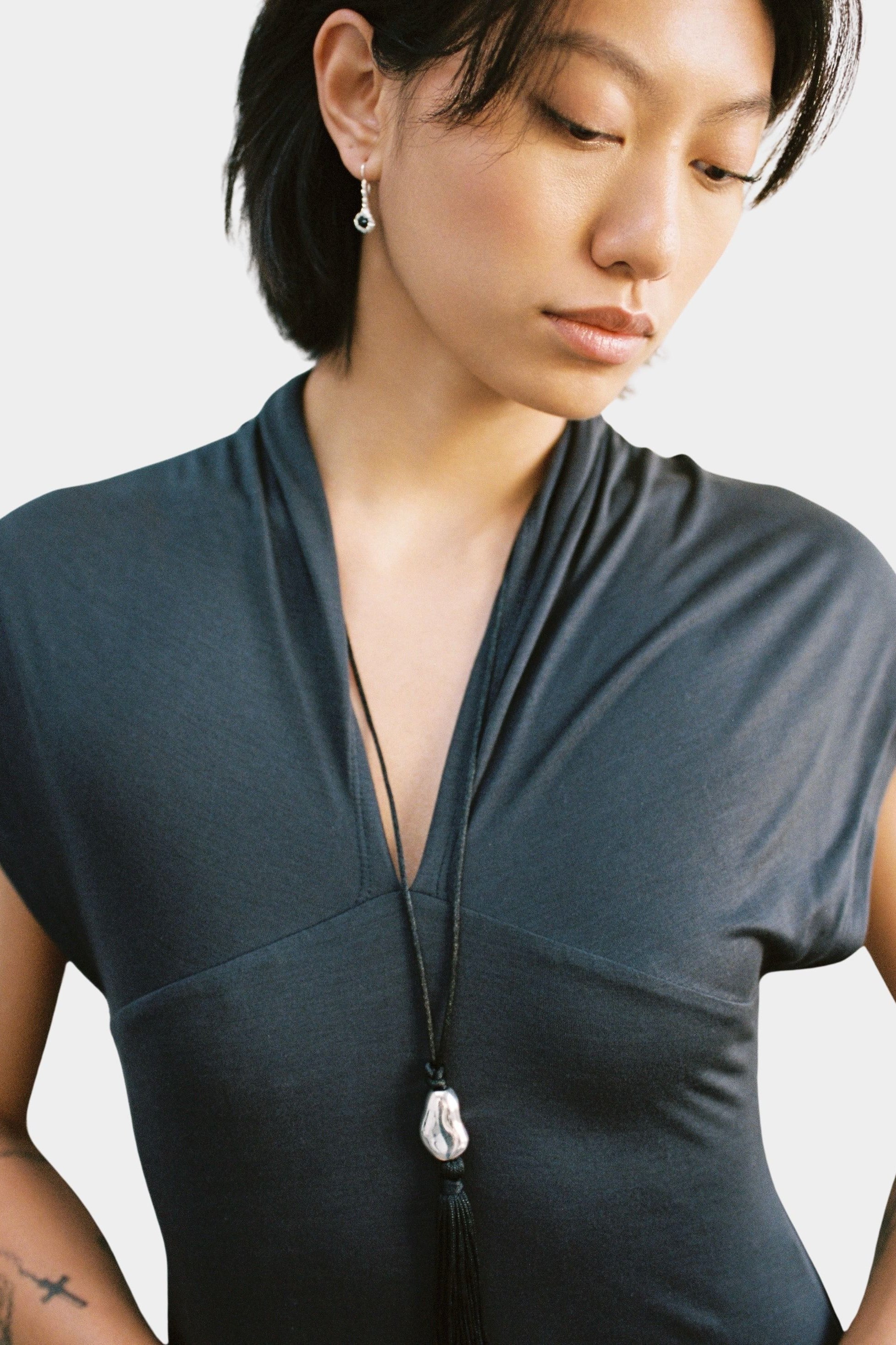 Miriam Necklace in silver Wolf Circus worn full length black cord tassel necklace on model
