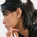 Silver sun shaped hair clip barrette side view holding hair back
