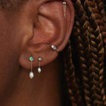 Large opal and pearl shower earrings worn in a layered WWAKE ear stack