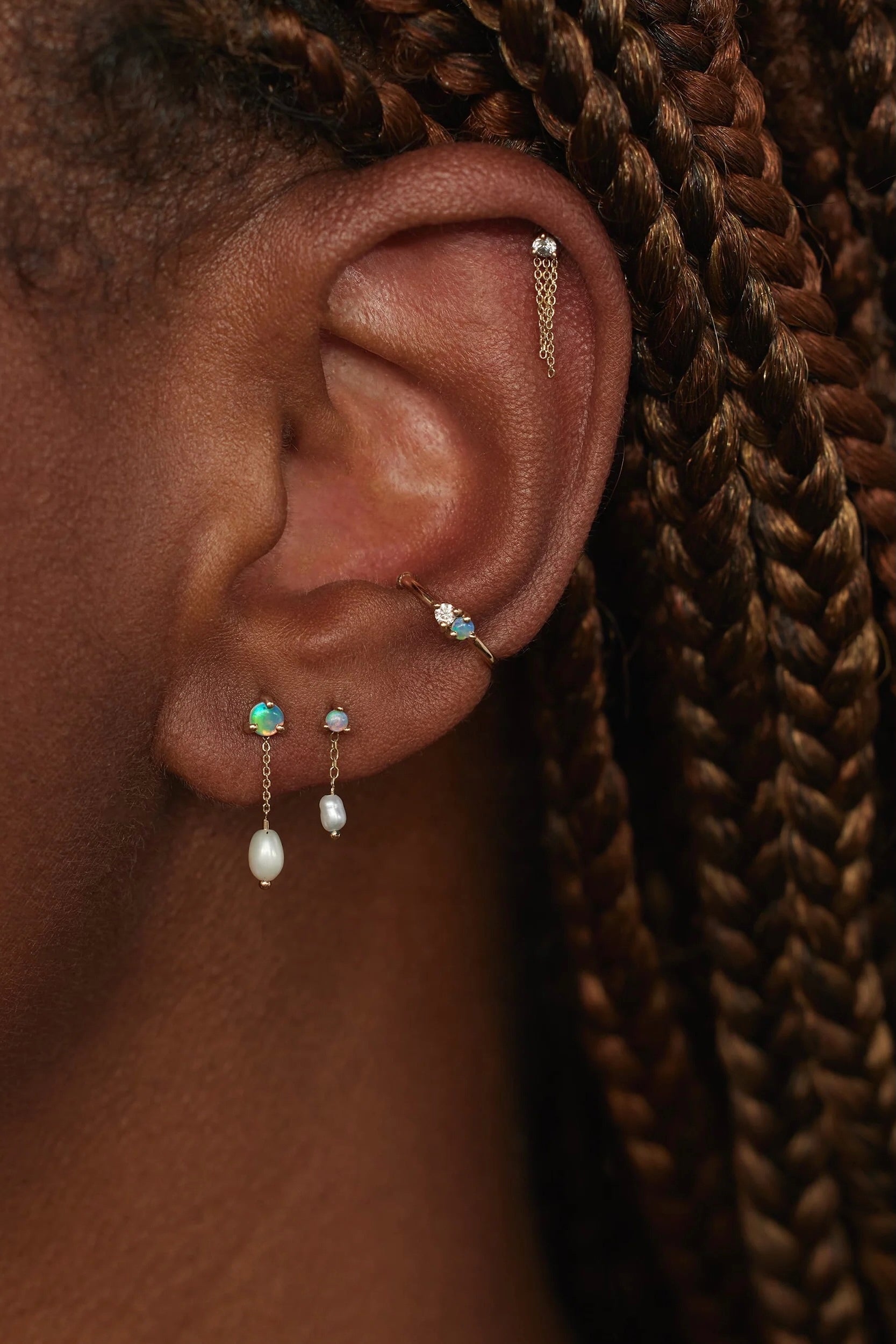 Large opal and pearl shower earrings worn in a layered WWAKE ear stack