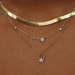 Opal and diamond linear chain necklace layered with delicate gemstone jewelry