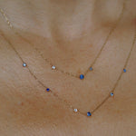 WWAKE sapphire fine jewelry necklace layered with another gemstone necklace, showing delicate gold chains and blue stones