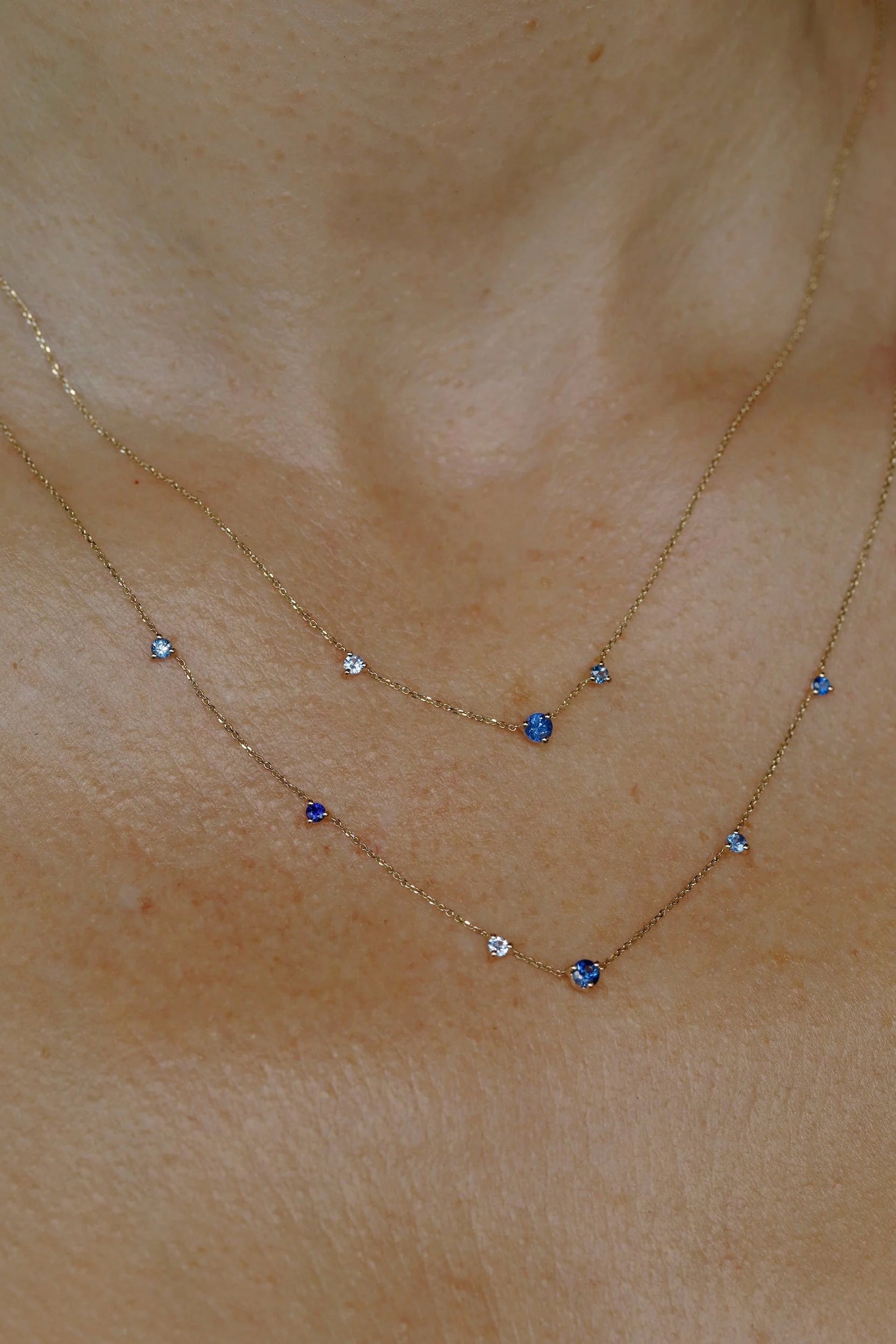 WWAKE sapphire fine jewelry necklace layered with another gemstone necklace, showing delicate gold chains and blue stones